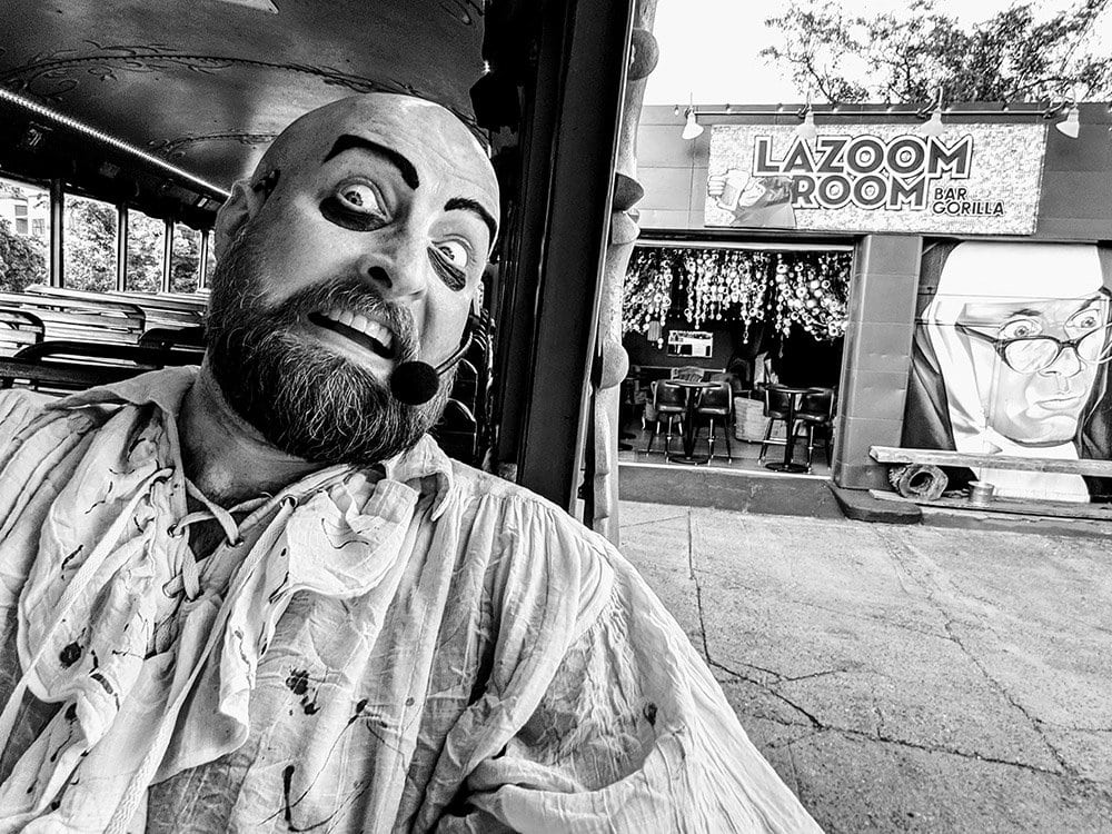 bald man with dark beard andscary Halloween makeup in black and white photo