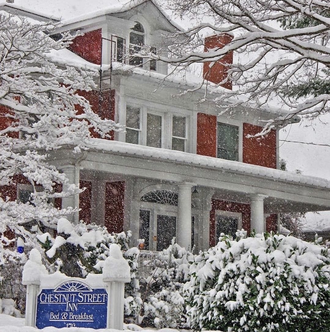 A red brick building covered in white snow