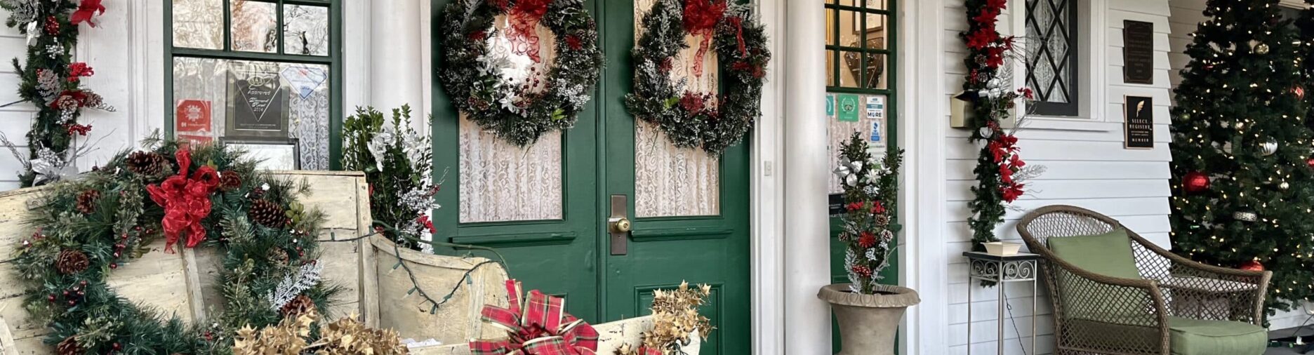 double door front door porch with red and green decorations